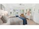 Bright guest bedroom featuring large windows with shutters, hardwood floors, two twin beds and neutral decor at 45 Seawatch Lake Dr, Boca Grande, FL 33921