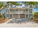 Beautiful two-story house with a white picket fence, driveway, and lush landscaping at 45 Seawatch Lake Dr, Boca Grande, FL 33921