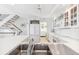 Modern kitchen with stainless steel appliances, stone countertops and white cabinets at 45 Seawatch Lake Dr, Boca Grande, FL 33921
