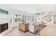 Bright living room with bay window, hardwood floors, fireplace and comfortable seating at 45 Seawatch Lake Dr, Boca Grande, FL 33921