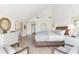 Large bedroom with hardwood flooring and ensuite bathroom featuring a spacious dresser and stylish decor at 45 Seawatch Lake Dr, Boca Grande, FL 33921