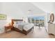 Light and bright bedroom features vaulted ceilings, hardwood flooring, and sliding door to the balcony at 45 Seawatch Lake Dr, Boca Grande, FL 33921