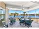 Covered screened porch with seating that overlooks a beautiful view of the water at 45 Seawatch Lake Dr, Boca Grande, FL 33921