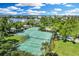Overhead view of community tennis courts surrounded by lush landscaping at 45 Seawatch Lake Dr, Boca Grande, FL 33921