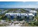 Aerial view of condo building on beach with lush vegetation and blue ocean at 5000 Gasparilla Rd # 73A, Boca Grande, FL 33921