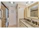 Bathroom with a granite vanity, tiled shower with glass door, and built-in storage at 5000 Gasparilla Rd # 73A, Boca Grande, FL 33921