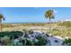 Lush landscaping and a stone walkway to the gorgeous beach and Gulf of Mexico at 5000 Gasparilla Rd # 73A, Boca Grande, FL 33921
