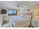 Cozy bedroom with ceiling fan and large window allowing natural light at 5000 Gasparilla Rd # 73A, Boca Grande, FL 33921