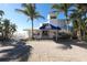 Elegant clubhouse entrance with manicured landscaping and ample parking at 5000 Gasparilla Rd # 73A, Boca Grande, FL 33921