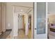 Hallway leading to a bathroom features tiled floors and a decorative glass paneled door at 5000 Gasparilla Rd # 73A, Boca Grande, FL 33921