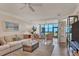 Bright living room featuring comfortable seating, ceiling fan, and view of the ocean at 5000 Gasparilla Rd # 73A, Boca Grande, FL 33921