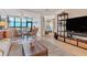Bright living room boasts tile floors, comfortable seating, and panoramic views of the ocean at 5000 Gasparilla Rd # 73A, Boca Grande, FL 33921