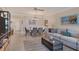 Open-concept living and dining area with comfortable seating, beach-themed art, and tile flooring at 5000 Gasparilla Rd # 73A, Boca Grande, FL 33921