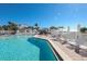 Sparkling pool surrounded by lounge chairs and beach umbrellas at 5000 Gasparilla Rd # 73A, Boca Grande, FL 33921