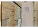 Close-up of a tiled shower with a glass door and grab bar in the bathroom at 5000 Gasparilla Rd # 73A, Boca Grande, FL 33921