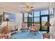 Relaxing sitting area features wicker furniture, ocean views, and ample natural light at 5000 Gasparilla Rd # 73A, Boca Grande, FL 33921