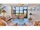 Bright sitting area with wicker furniture, ocean views, and beachy decor at 5000 Gasparilla Rd # 73A, Boca Grande, FL 33921
