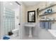 Bathroom with a pedestal sink and a glass block shower at 502 Pine Hollow Cir # 502, Englewood, FL 34223
