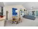Bright dining area with wood table and white chairs, near living room at 502 Pine Hollow Cir # 502, Englewood, FL 34223