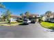 Condo building with parking and lush landscaping at 502 Pine Hollow Cir # 502, Englewood, FL 34223