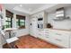 Modern kitchen with white cabinets, wood countertop and breakfast nook at 502 Pine Hollow Cir # 502, Englewood, FL 34223