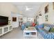 Relaxing living room with blue striped sofas and a coffee table at 502 Pine Hollow Cir # 502, Englewood, FL 34223