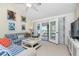 Comfortable living room with blue striped sofa and access to patio at 502 Pine Hollow Cir # 502, Englewood, FL 34223