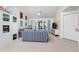 Spacious living room with blue striped sofa and access to balcony at 502 Pine Hollow Cir # 502, Englewood, FL 34223