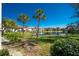 Waterfront view of a condo community with lush landscaping at 502 Pine Hollow Cir # 502, Englewood, FL 34223