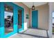 Beach house features double bright teal doors and a smaller teal door at 534 Gulf Blvd, Placida, FL 33946