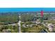 Aerial view showcasing property location amidst lush greenery, waterways, and nearby beaches. Arrow indicates the home's location at 5868 Denison Dr, Venice, FL 34293