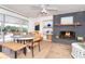 Cozy dining room with a fireplace, a large window, and a rustic table at 5868 Denison Dr, Venice, FL 34293