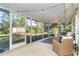 Relaxing screened porch with seating and string lights at 5868 Denison Dr, Venice, FL 34293