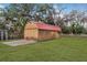 Large wooden workshop with red metal roof at 651 Dixon Rd, Venice, FL 34292