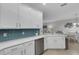 White kitchen with stainless steel appliances and granite counters at 6630 Willowshire Way, Bradenton, FL 34212