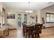 Open dining room with a traditional wooden table, chairs and sliding glass doors at 710 Albee W Rd, Nokomis, FL 34275