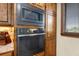 Modern kitchen with stainless steel microwave and oven, complemented by wood cabinetry at 710 Albee W Rd, Nokomis, FL 34275