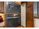 Modern kitchen with stainless steel microwave and oven, complemented by wood cabinetry at 710 Albee W Rd, Nokomis, FL 34275