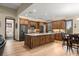 Open kitchen features custom cabinetry, island, and modern stainless steel appliances at 710 Albee W Rd, Nokomis, FL 34275