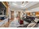 Spacious living room featuring a stone accent wall, hardwood floors, coffered ceilings, and barn doors to the office at 710 Albee W Rd, Nokomis, FL 34275