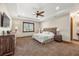 Cozy bedroom with neutral tones, a ceiling fan, and a large window with blinds at 710 Albee W Rd, Nokomis, FL 34275