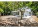 House exterior showcasing a large backyard and screened porch at 7147 Lago St, Sarasota, FL 34241