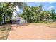 Brick driveway leads to a charming house nestled in lush greenery at 7147 Lago St, Sarasota, FL 34241