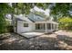 Rear view of the house showing the screened porch and patio at 7147 Lago St, Sarasota, FL 34241