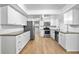 Bright kitchen featuring white cabinets, granite counters and stainless steel appliances at 7147 Lago St, Sarasota, FL 34241