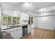 Modern white kitchen with granite countertops and stainless steel appliances at 7147 Lago St, Sarasota, FL 34241