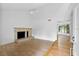 Spacious living room with hardwood floors and a stone fireplace at 7147 Lago St, Sarasota, FL 34241