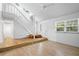 Light and airy living room with hardwood floors and staircase at 7147 Lago St, Sarasota, FL 34241