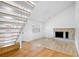 Open living area with hardwood floors, fireplace and staircase at 7147 Lago St, Sarasota, FL 34241