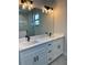 Double vanity bathroom with a large mirror and modern lighting at 7330 Printer St, Port Charlotte, FL 33981